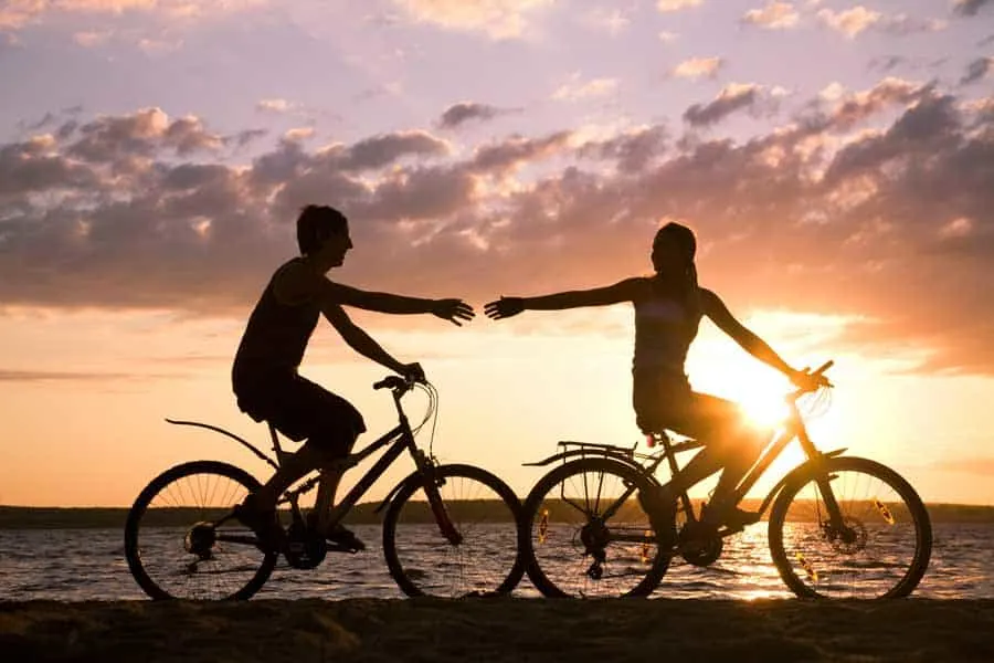 Couple riding bike in the sunset