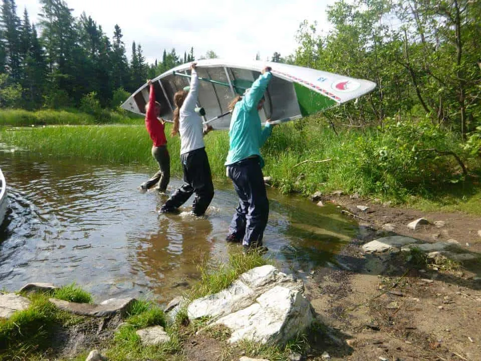 Girl Scouts Carrying Canoe