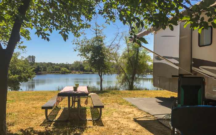 RV and picnic table by lake