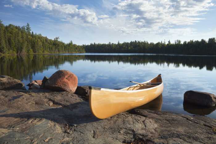 Fishing canoe along the rocky shores of a Minnesota lake 