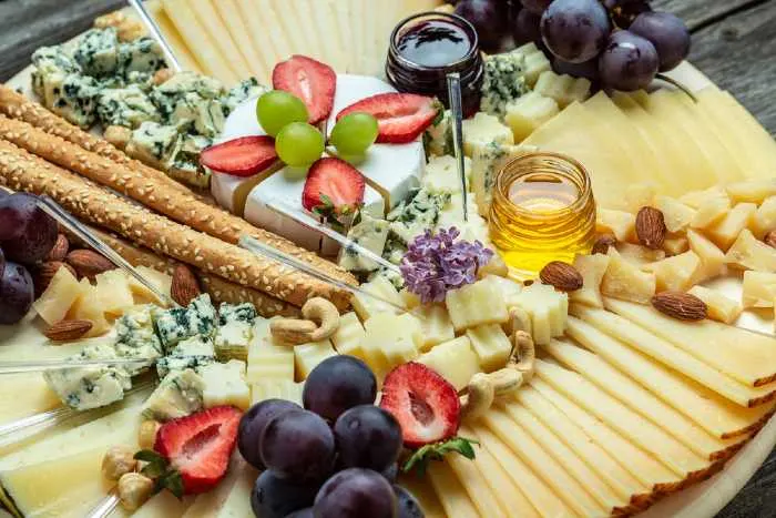 Antipasto Cheese board of various types of soft and hard cheese at one of the best Italian restaurants in Minnesota.