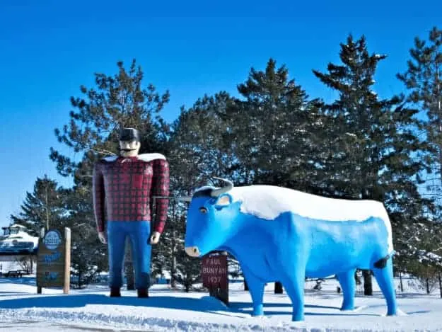 Sculptures of Paul Bunyan and Babe the Blue Ox in the snow in Bemidji, one of the best places to visit in Minnesota.