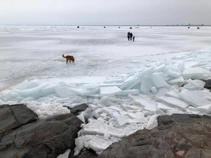 Ice fishing on frozen lake.