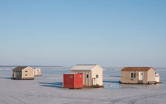 Ice houses on frozen lake