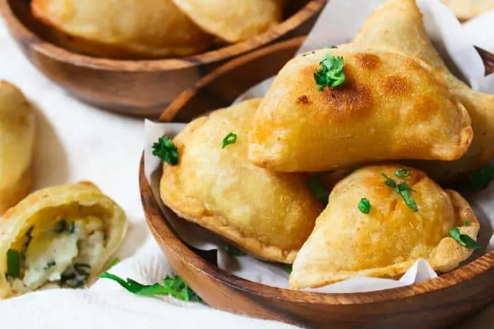 Potatoe Cheese Perogies in wooden bowl.