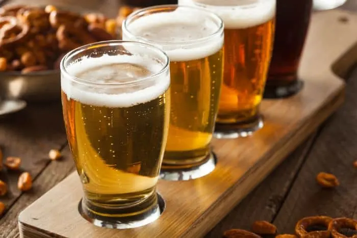 Assorted beers in a flight, ready for tasting at one of the best things to do in St. Cloud, Minnesota