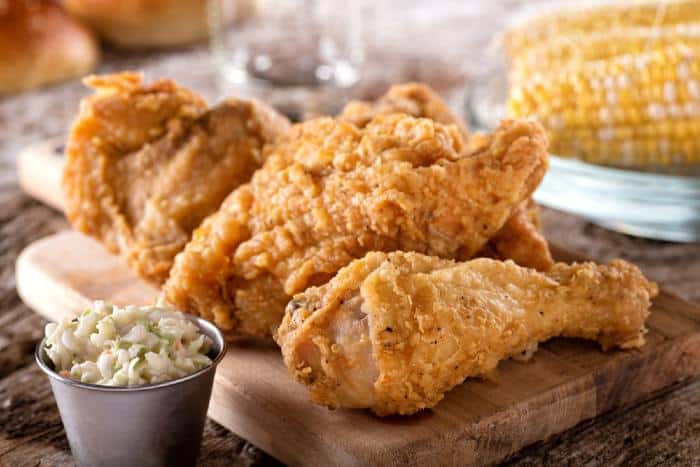 Delicious crispy fried chicken with coleslaw and corn on the cob at one of the best fried chicken places in Minnesota.