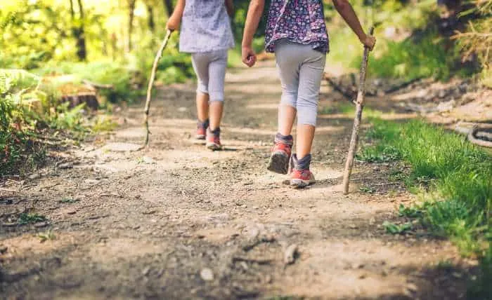 Girls are walking trough forest path