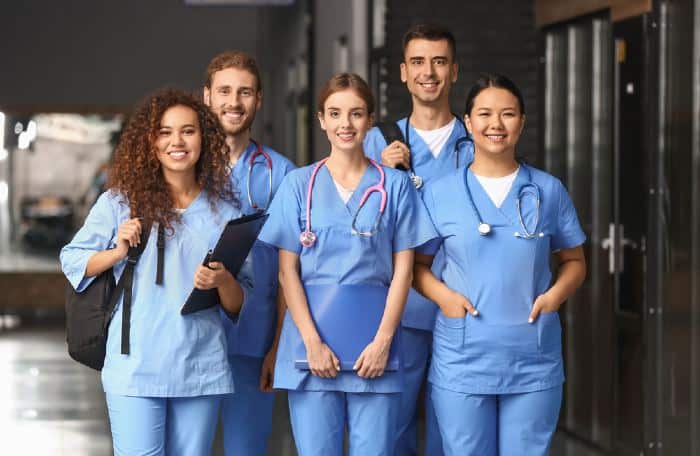 Group of students in corridor of one of the best colleges in Minnesota for pre-med.