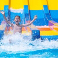 Boy sliding down water slide