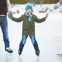 Happy boy skating with family