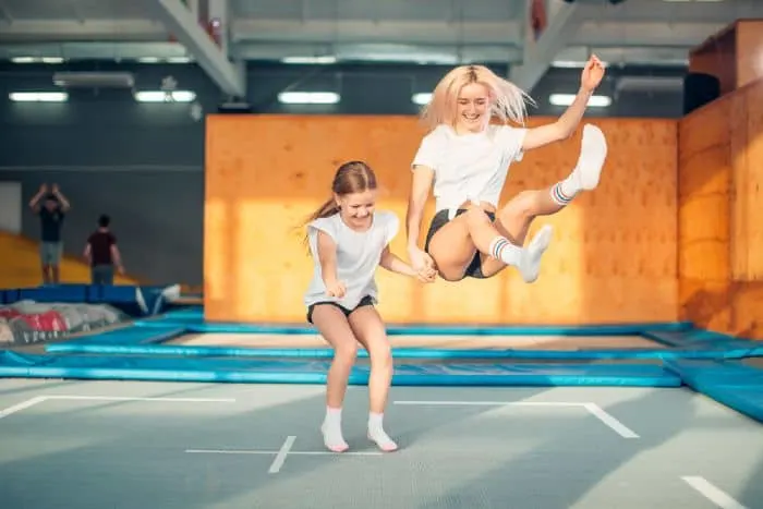  Two girls bouncing in the trampoline park