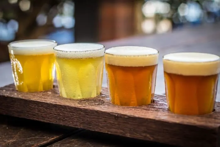 Beer tasting paddle with peanuts on a wooden table