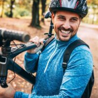 Man with trail bike on trail