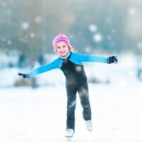 Young girl ice skating in the snow