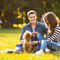 Couple and dog at park