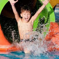 Boy on water slide