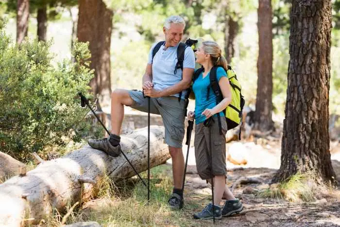 Couple smiling and posing during a hike on the wood