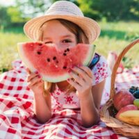 Young girl eating watermelon