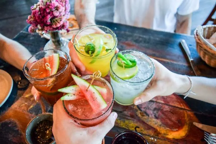 Friends toasting with cocktails at one of the most refreshing things to do in North St. Paul