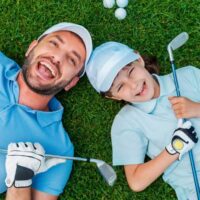 Father and son golfing and happy