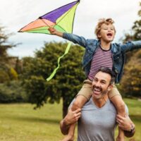 man and son flying kite