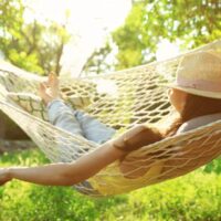 Woman on outdoor hammock