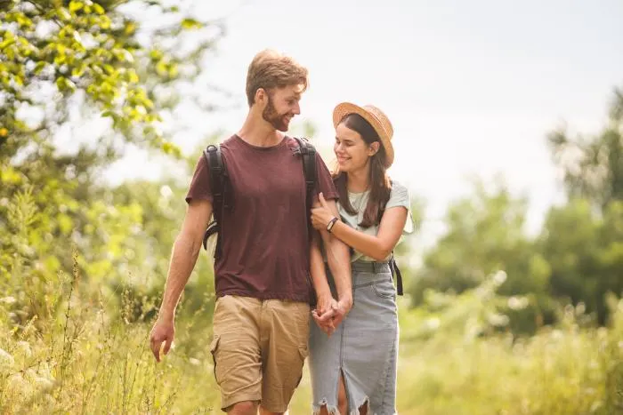 Young couple walking through park