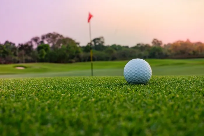 A long putt on the green as sunset closes in at one of the geat things to do in Lake Elmo

