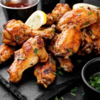 Baked chicken wings on slate
