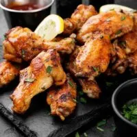 Baked chicken wings on slate
