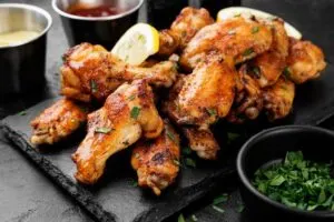 Baked chicken wings on slate