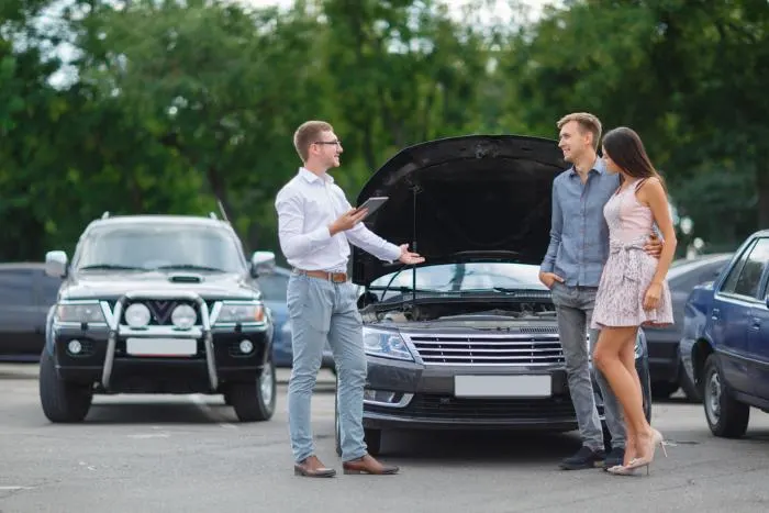 A young couple buy a car at one of the best used car dealerships in Minnesota