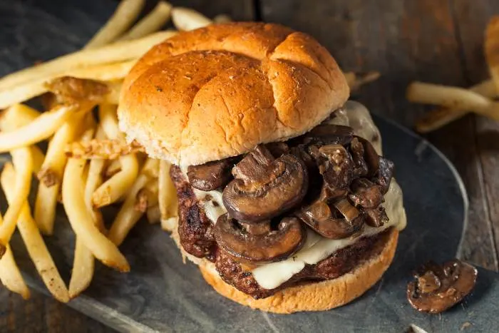 Savor a tasty mushroom and swiss cheese hamburger with fries at one of the most delicious things to do in Lake Elmo