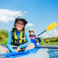 Boys paddling in a kayak