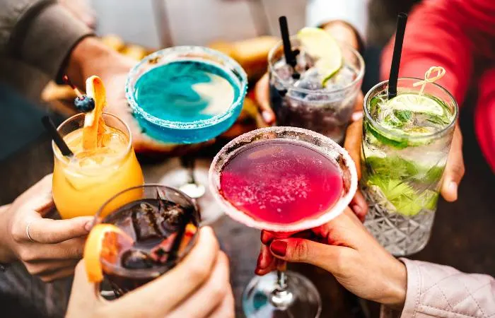 Friends drinking cocktails at happy hour; one of the most refreshing things to do in Vadnais Heights