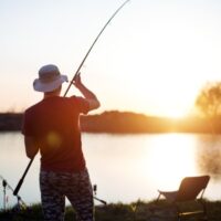 Man fishing at sunset