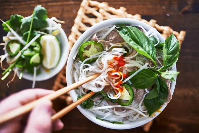 Delicious Vietnamese pho with spicy sriracha sauce from one of the best restaurants in Minneapolis