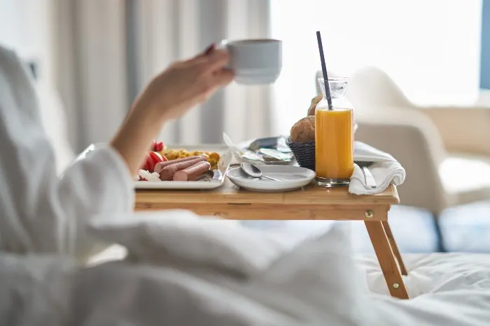 Woman eating breakfast in hotel room
