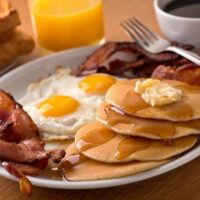 Pancakes, bacon eggs and toast