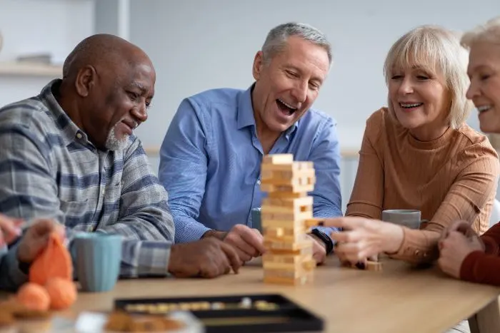 Aging friends playing game on table