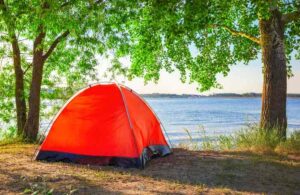 Red tent lakeside camping