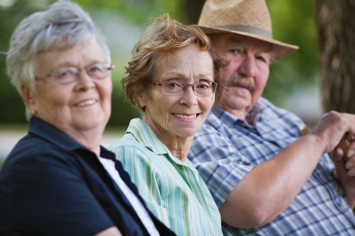 Senior friends sitting together in park