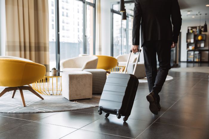 Picture of a man with a suitcase in one of the best places to stay in Minnesota.