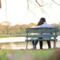 Couple on lakeside bench