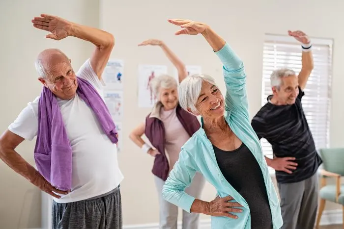 Retirement communities in Minnesota: Senior people stretching at the gym