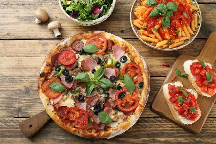 pizza pasta with tomato sauce and salad bowl