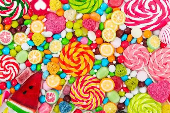 Colorful lollipops and different colored round candy. Top view.
