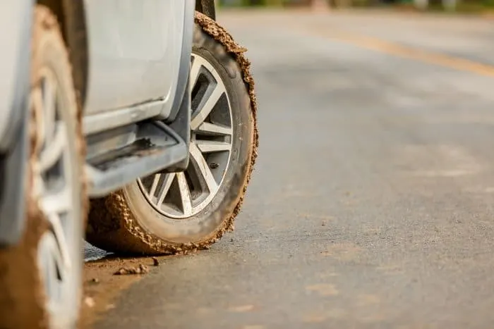 Suv with muddy tires driven on the roadway breaks one of the weird Minnesota laws.