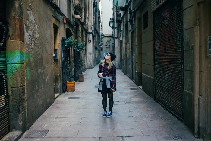 Young woman exploring the city alley